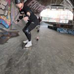 Jason slalom on his skateboard